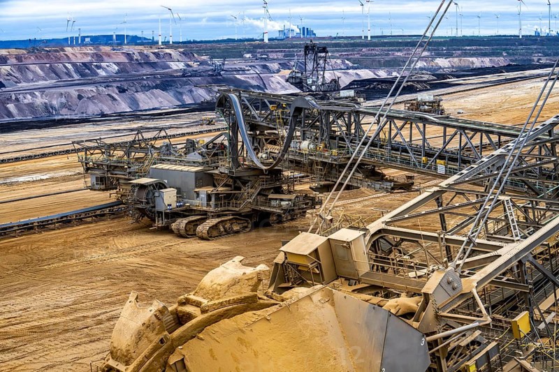 Opencast lignite mine Garzweiler 2, bucket wheel excavator 261 excavating the surface, at the rest of the hamlet of Lützerath, behind excavator 288, mining lignite, Neurath lignite-fired power station, wind farm, Erkelenz, North Rhine-Westphalia, Germany, Europe