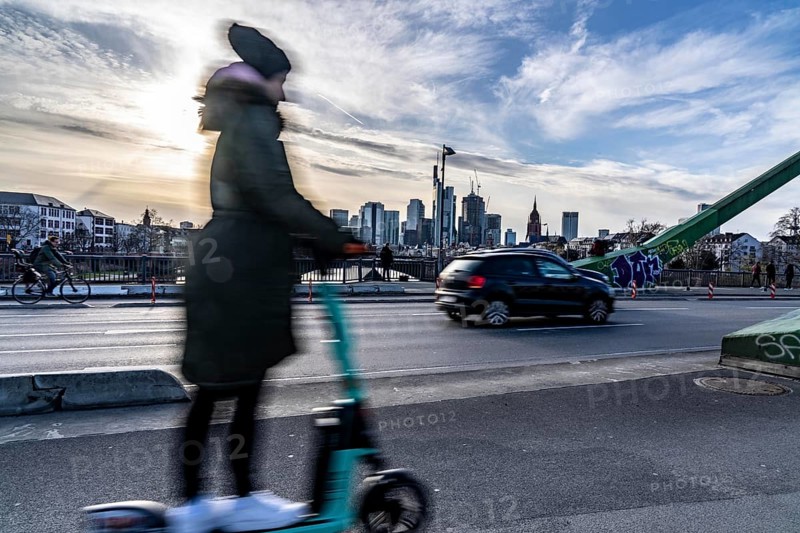 Skyline of Frankfurt am Main, skyscrapers, e-scooter rider on the Flößerbrücke, Hesse, Germany, Europe