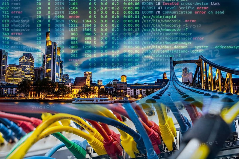 Symbolic image of critical infrastructure, skyline of Frankfurt am Main, data cable, hacker code