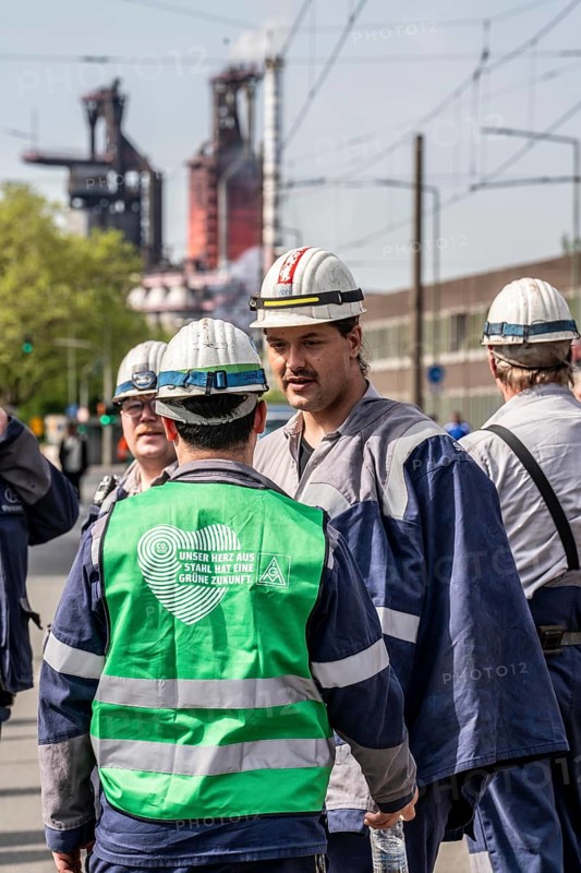 Steelworkers at a demonstration in front of the headquarters of ThyssenKrupp Steel Europe in Duisburg, against massive job cuts, after the participation of a foreign investor in the group, in the background the blast furnaces 8 and 9, Duisburg North Rhine-Westphalia, Germany, Europe