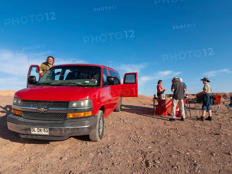 Red car, Chrysler van and travelling group at camping breakfast in Atacama Desert, Chile, South America