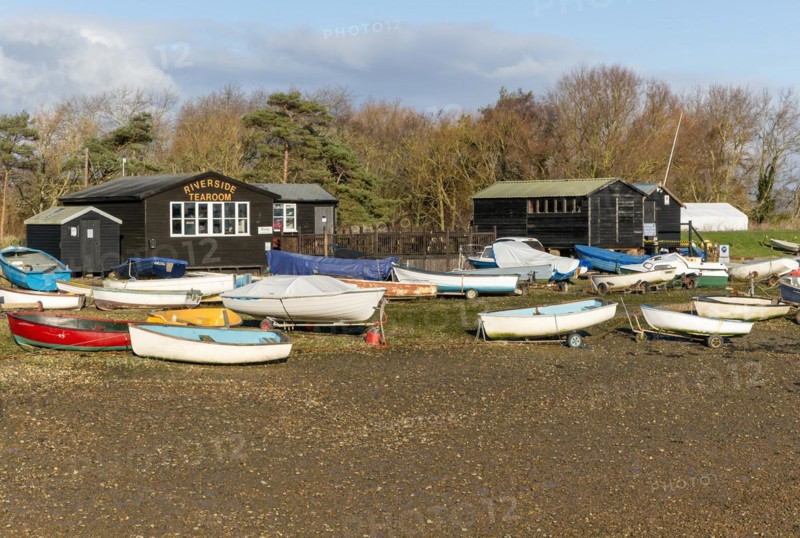 Fishing sheds and boats dinghies on trailers, Riverside tearoom, Orford, Suffolk, England, UK