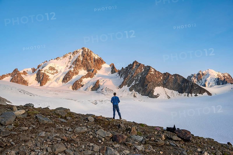 High alpine mountain landscape at sunset, Glacier du Tour, mountaineer in front of glacier and mountain peak, summit of Aiguille de Chardonnet, Chamonix, Haute-Savoie, France, Europe