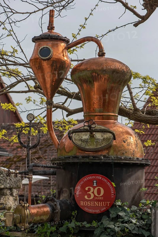 Distillery, distilling apparatus as an advertisement in front of a distillery, Lower Franconia, Bavaria, Germany, Europe