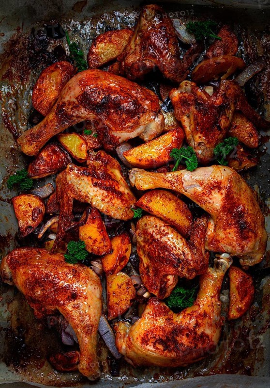 Roast chicken legs with potatoes and onions in the oven, homemade. No people