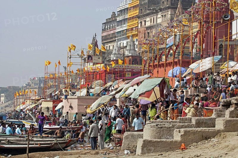Hindu pilgrims gathering at a ghat to bathe in the Ganges river in Varanasi, Uttar Pradesh, India, Asia