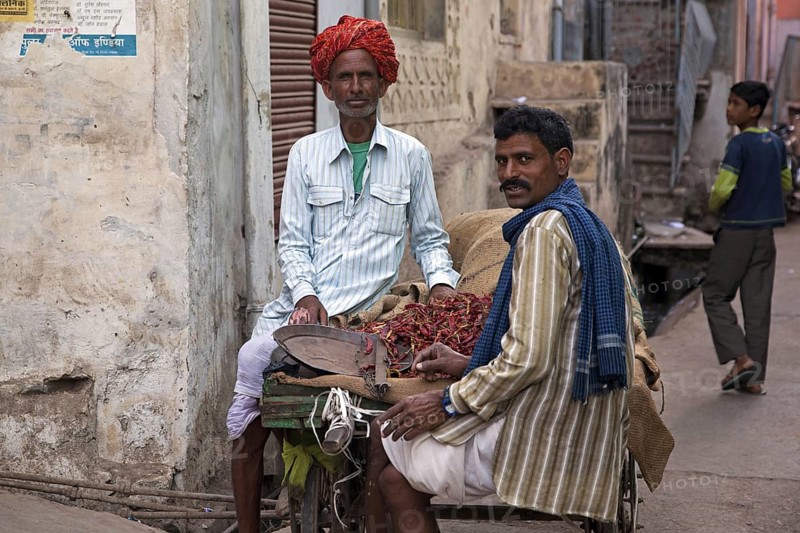 Men selling red peppers on street in Bundi, Rajasthan, India, Asia