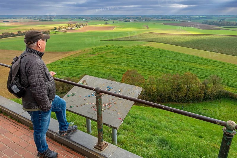 Elderly man looking over the 1815 Waterloo battlefield from top of the Lion's Mound at sunset in autumn, Braine-l'Alleud, Wallonia, Belgium, Europe