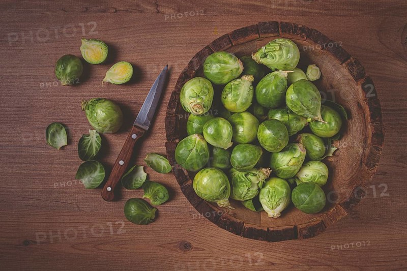 Fresh Brussels sprouts, raw, top view, on a wooden table, no people