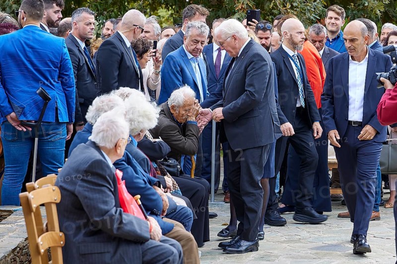 Federal President Frank-Walter Steinmeier, Survivors of the massacre of 3.6.1941, A formal handshake between an elderly man and another during a large gathering, Visit of Federal President Frank-Walter Steinmeier to Kandanos on 31 October 2024, Federal President, Frank-Walter Steinmeier, Memorial, War crimes, Nazis, Wehrmacht crimes, World War II, Kandanos, Southwest Crete, Crete, Greek Islands, Greece, Europe