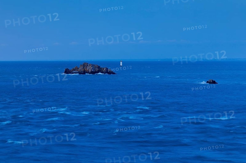 Evening view from the Pointe du Grouin with a view of the Phare de la Pierre-de-Herpin and striking rocks in the water, near Cancale in northern Brittany, France, Europe