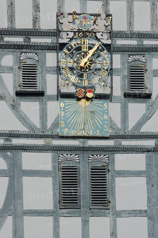 Golden clock with grey half-timbering and shutters, sundial, half-timbered house, wooden beams, grey, white, decorations, craftsmanship, date, 1630, detail, town hall, market square, Butzbach, Wetterau, Hesse, Germany, Europe
