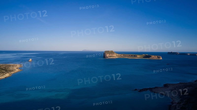 Drone shot, Remote island with wide view of the clear blue ocean and bright sky, Venetian Sea Fortress, Gramvoussa, Gramvoussa Peninsula, Pirate Bay, Balos, Lagoon, Northwest Crete, Crete, Greek Islands, Greece, Europe