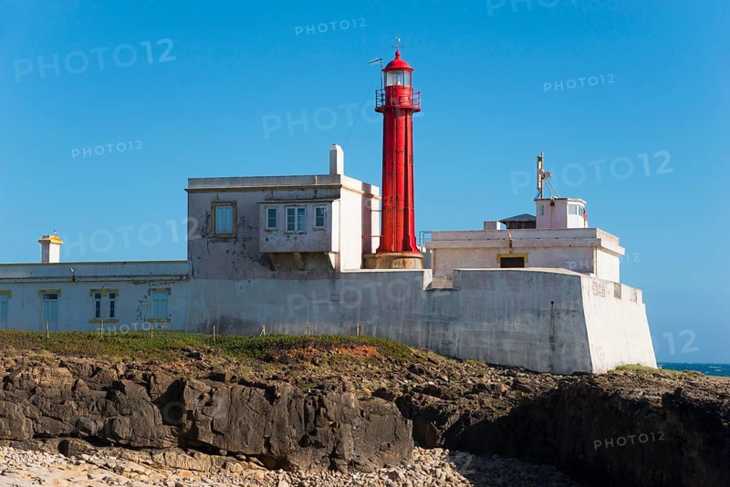 Close-up of a lighthouse on a rocky coast under a blue sky, Farol do Cabo Raso, São Brás de Sanxete fortress, Estoril, Cascais, Parque Natural de Sintra-Cascais, Portugal, Europe