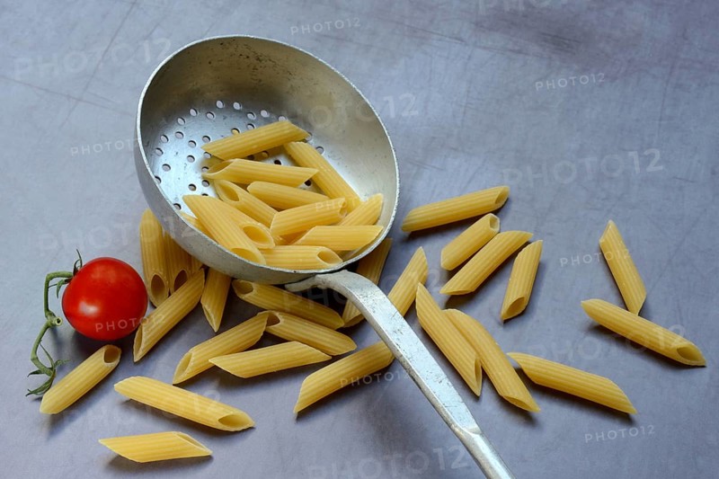 Pasta, Italian penne in a sieve ladle