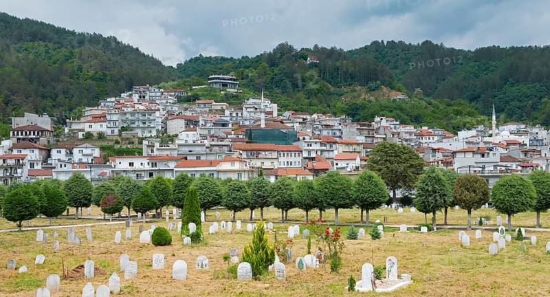 Landscape view of a village with white houses, red roof tiles and a minaret, under a cloudy sky, Echinos, centre of the Pomaks, Myki, Xanthi, Eastern Macedonia and Thrace, Greece, Europe