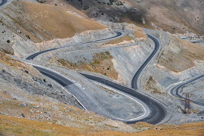 Winding roads on the Pamir Highway, mountain road through an eroded mountain landscape, Kyrgyzstan, Asia