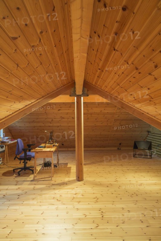Wooden desk table with computer and black metal sitting chair in home office set-up on mezzanine inside a piece sur piece Scots pine log home, Quebec, Canada, North America
