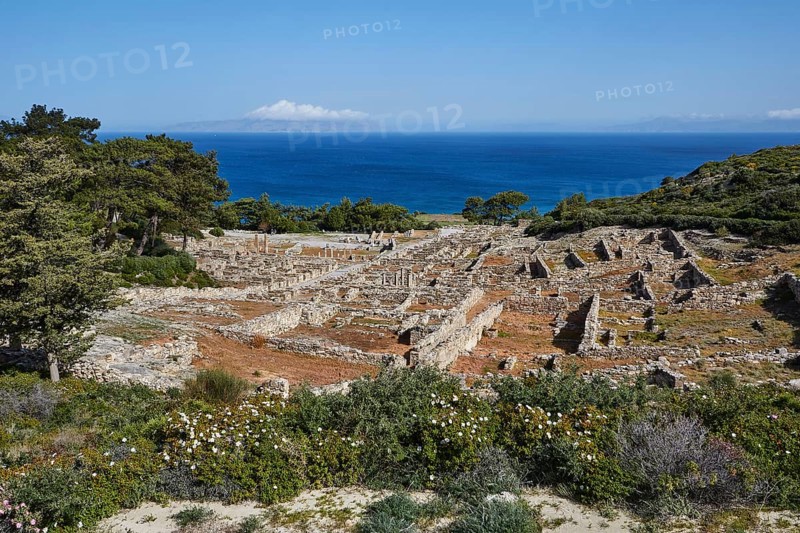 Ruins of an ancient city overlooking the sea, surrounded by vegetation under a blue sky, Kamiros, Archaeological site, Ancient city, Foundation of Doric Greeks, Rhodes, Dodecanese, Greek Islands, Greece, Europe