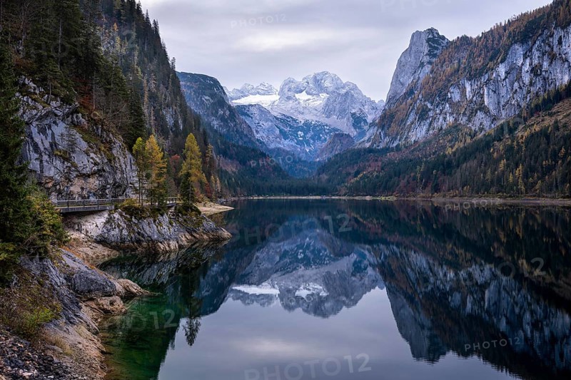 The Vordere Gosausee lake in autumn with a view of the Dachstein mountain range. The Gosaukamm on the right. Cloudy sky. Reflection. Vorderer Gosausee, Gosau, Gosau valley, Salzkammergut, Upper Austria, Austria, Europe