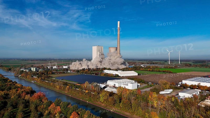 Demolition of a chimney with smoke cloud, surrounded by autumn landscape and wind turbines, blasting of the ash silos, Mehrum coal-fired power plant, Peine district, Lower Saxony, Germany, Europe
