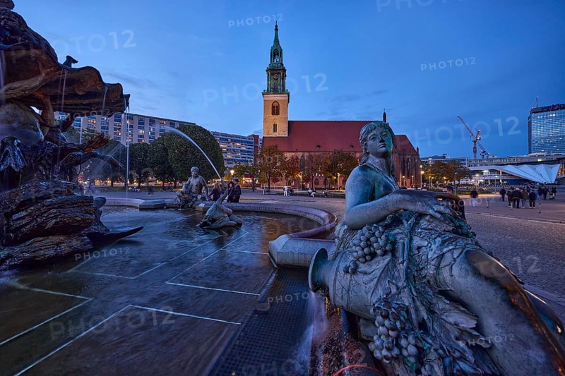 Bronze figure of a woman with grapes of the Neptune Fountain and St. Mary's Church at dusk, Karl-Liebknecht-Straße, Berlin, capital city, independent city, federal state Berlin, Germany, Europe