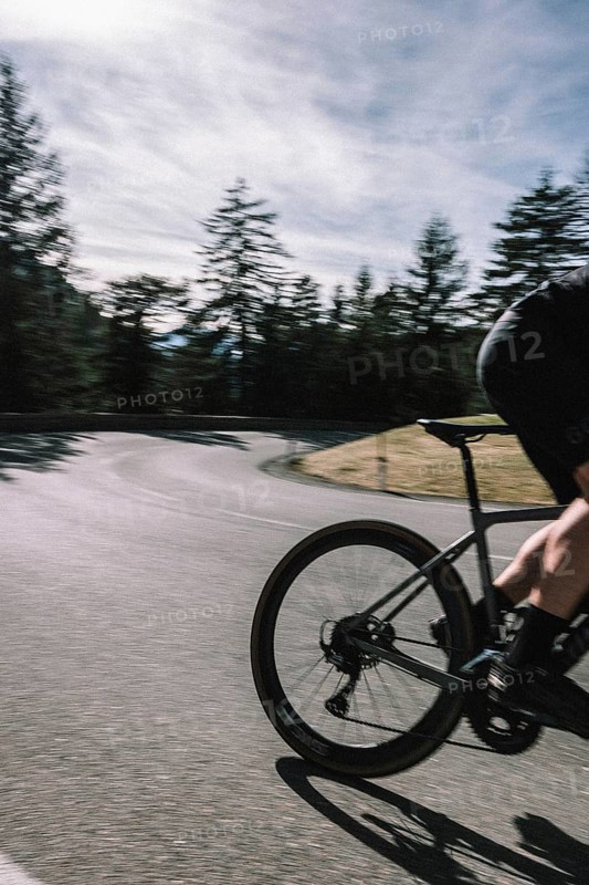 Road bike rider in spring between Lechtal and Tannheimer Tal in front of picturesque scenery of the Alps, Tyrol, Austria, Europe