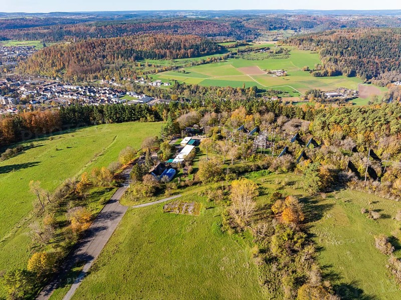 Wide landscape with fields, forests and a small village surrounded by autumnal trees, high ropes course, Nagold, Black Forest, Germany, Europe