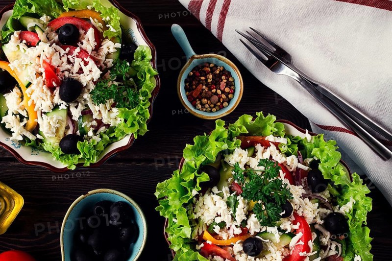 Traditional Bulgarian dish, Shopska salad, on a wooden table, salad of fresh vegetables, top view, close-up, no people, Bulgarian food, Bulgarian cuisine, salad, vegetables