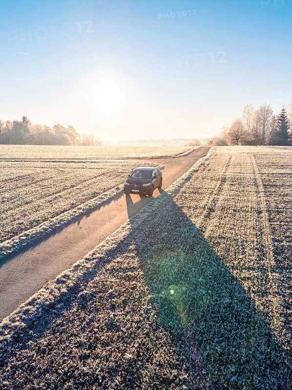 An SUV drives along a frosty country lane in bright sunshine, Car Sharing, electric car, Volkswagen ID 5, Gechingen, Hecken und Gäu Region, Black Forest, Germany, Europe