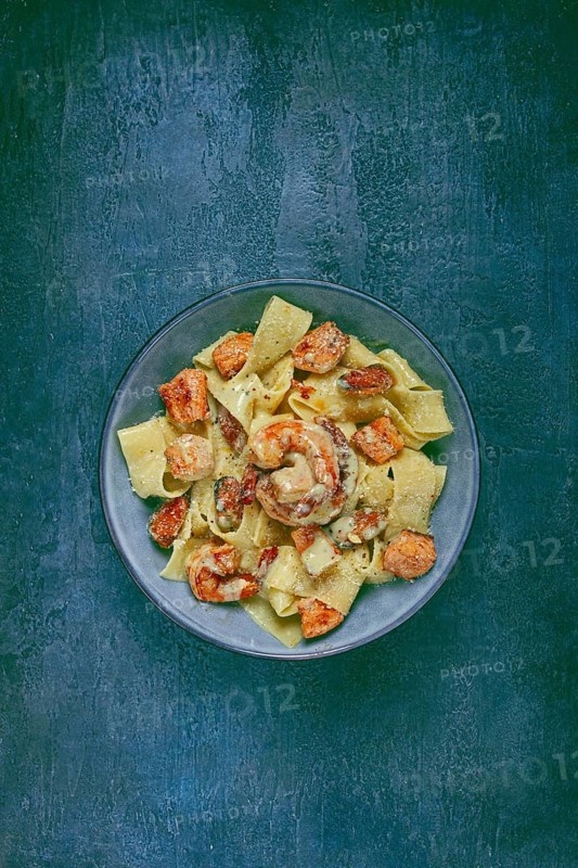 Papardelle pasta in creamy sauce with seafood, homemade, no people