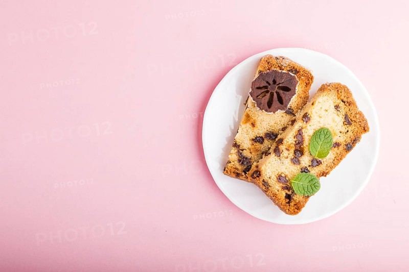 Homemade cake with raisins and dried persimmon on a pink pastel background. Top view, flat lay, copy space