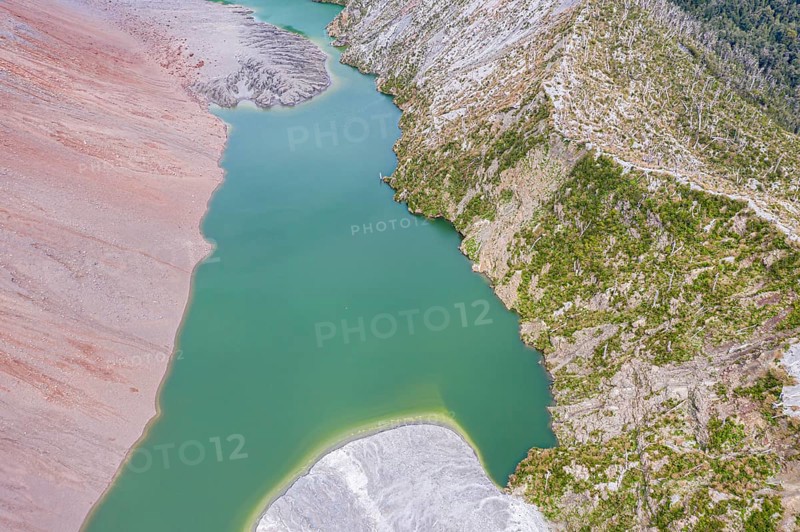 Dead trees, crater rim of Chaiten volcano, colored rock, small lake, aerial view, Park Pumalin, Patagonia, Chile, South America