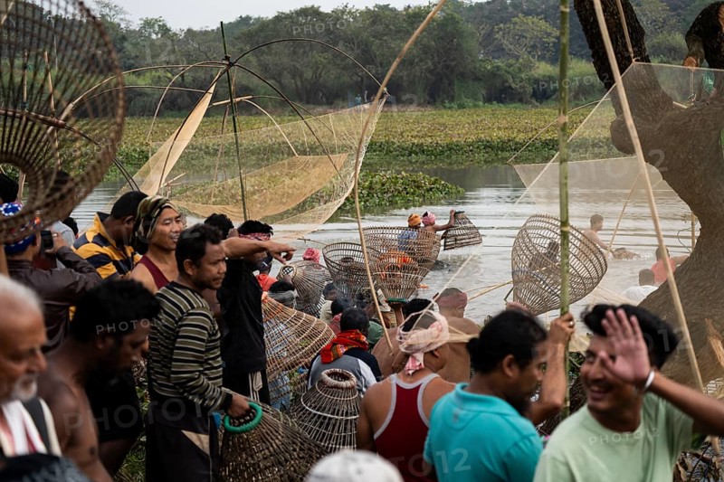 Villagers participate in a community fishing event on the occasion of the Bhogali Bihu festival at Panbari village in Assam on 13 January 2025. Magh Bihu, also known as Bhogali Bihu, is one of the most vibrant festivals celebrated in Assam and other parts of Northeast India