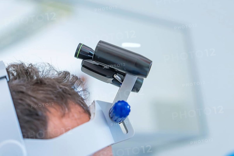 Modern head holder with zoom lens in blue and black for medical use, dental practice, Germany, Europe