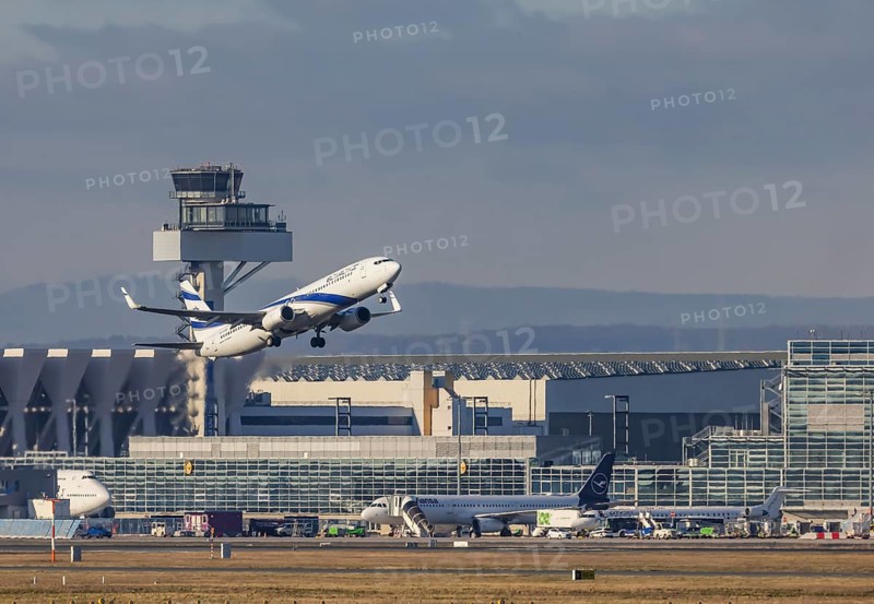 Aircraft taking off in front of the terminal and tower at Fraport Airport. Aircraft registration: 4X-EHB, Boeing 737, El Al Israel Airlines. Frankfurt am Main, Hesse, Germany, Europe