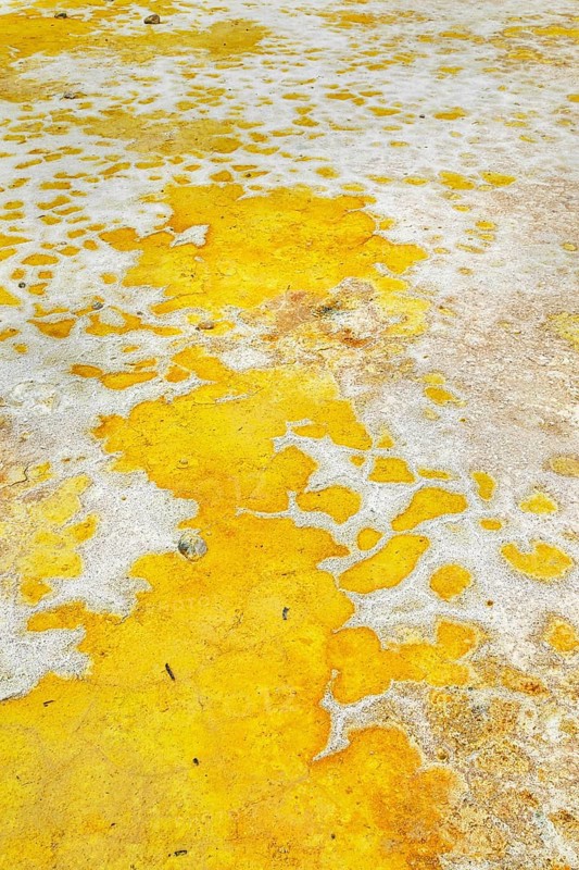 Splashes of sulphur colouring Stefanos crater ground, Nisyros Island, Dodecanese Islands, Greece, Europe