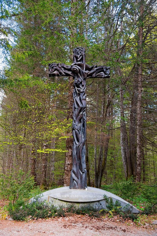 Wooden cross in a forest, surrounded by trees, symbolising Christian themes and peace, Jama pod Krenom, remembrance of the mass murders of World War II, forest near Kocevje, Kocevje, Gottschee, historical landscape of Lower Carniola, south-eastern Slovenia, Slovenia, Europe