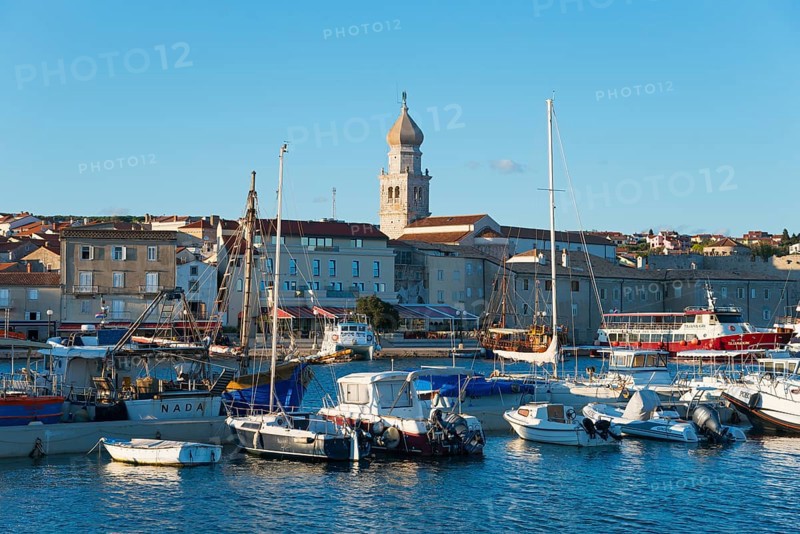 Coastal town at sunset with harbour and boats, in the background a church and historical buildings, harbour, old town, Krk town with St. Mary's basilica, island Krk, Kvarner Gulf bay, Primorje-Gorski kotar, Croatia, Europe