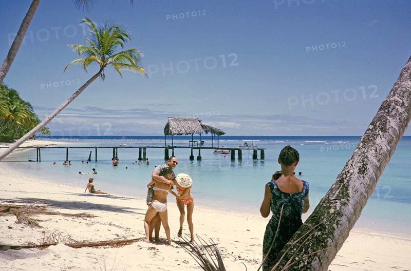 Tourists on sandy Buccoo beach Tobago, Trinidad and Tobago 1963 women playing around with man