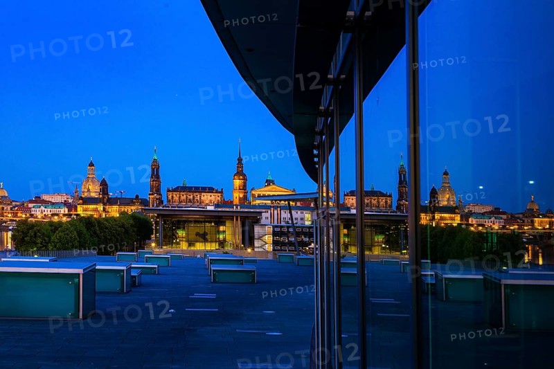 Reflection of the illuminated Old Town of Dresden in the façade of the Dresden Congress Centre