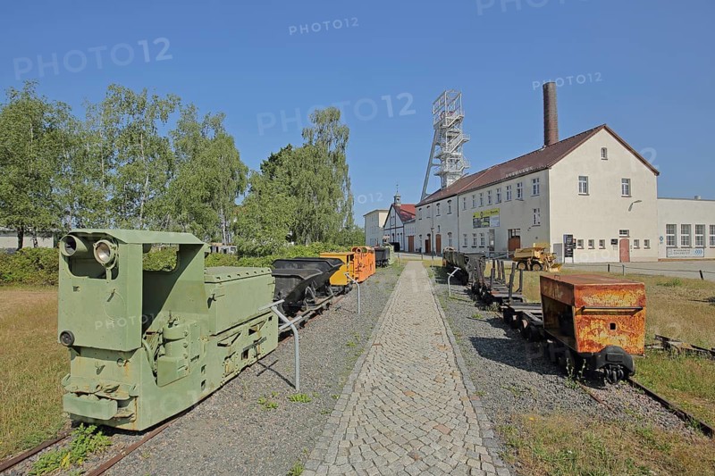 Rail vehicles Locomotive, lorries and dump truck with winding tower at the former mine Reiche Zeche Fundgrube Himmelfahrt, TU Bergakademie, UNESCO Montanregion, historical, Hunte, Hunt, Lore, tracks, symbol, colliery, mining, industry, ore mine, factory site, technical, university, rail vehicle, traction engines, Freiberg, Saxony, Germany, Europe