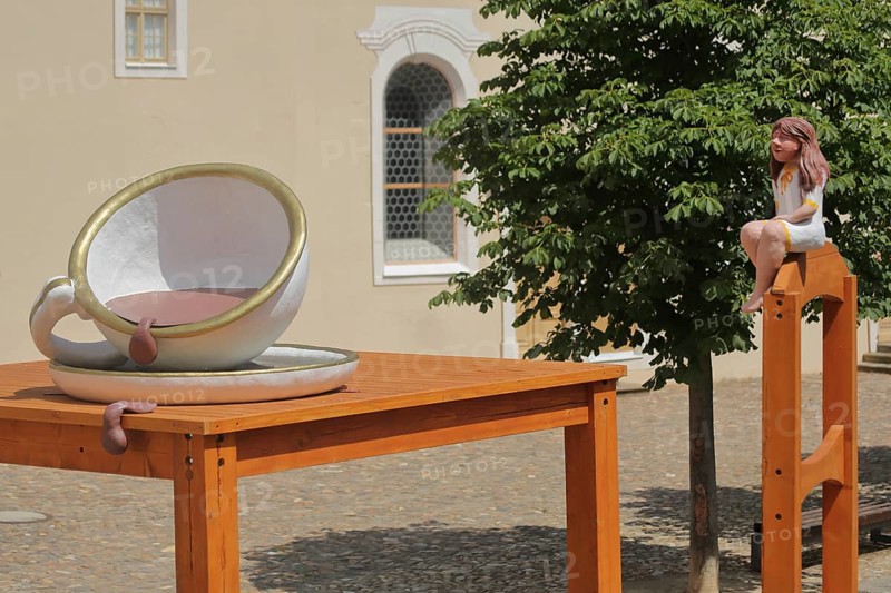 Sculpture Thumbelina with table and chair, cup, dishes, fairy tale figure, oversized, leak, liquid, flow, courtyard, small, tiny, castle, Lichtenwalde, Niederwiesa, Saxony, Germany, Europe