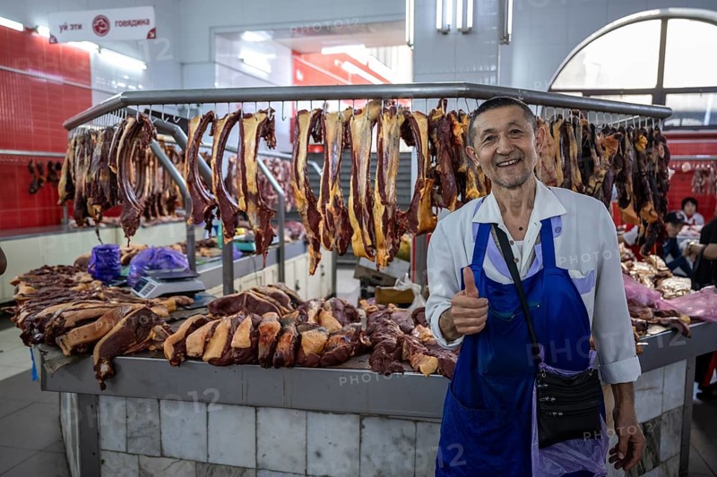 Butcher happy, fresh meat, market at Osh bazaar, Bishkek, Kyrgyzstan, Asia
