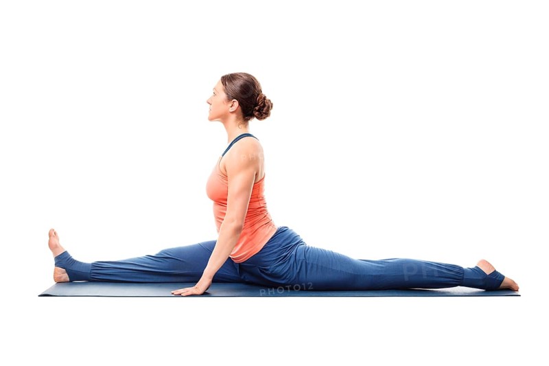 Woman doing Hatha Yoga asana Hanumanasana, monkey pose posture (splits) isolated on white background