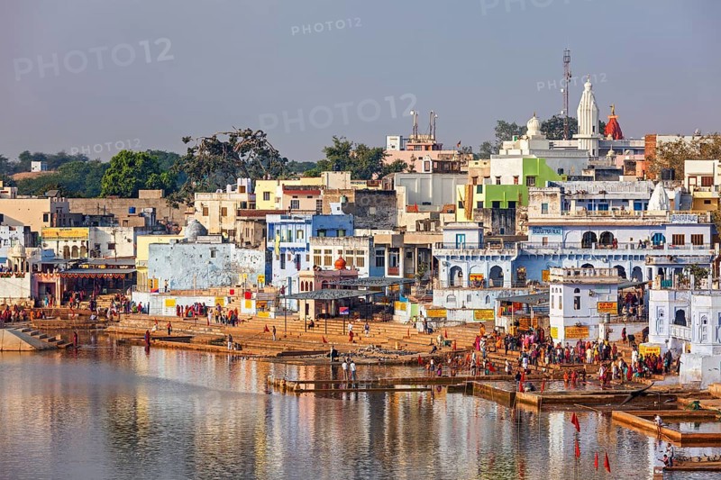 PUSHKAR, INDIA, NOVEMBER 20, 2012: Hindu devotees pilgrims bathing in sacred Puskhar lake (Sagar) on ghats of Pushkar, Rajasthan, India. Pushkar is holy city for Hinduists and famous for many Hindu temples