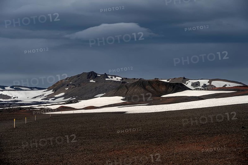 Snow-covered volcanic landscape with volcanic sand and petrified lava, crater of Askja volcano, Icelandic highlands, Iceland, Europe