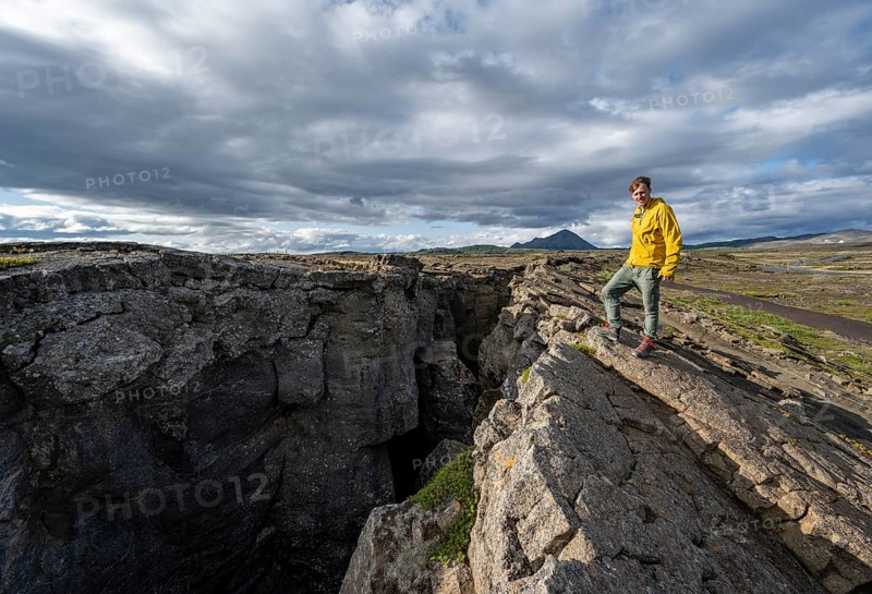 Tourist at a crevice, Grjótagjá, Myvatn, Iceland, Europe