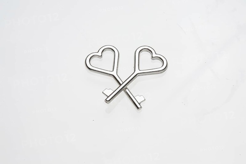 Two heart-shaped keys lie on top of each other