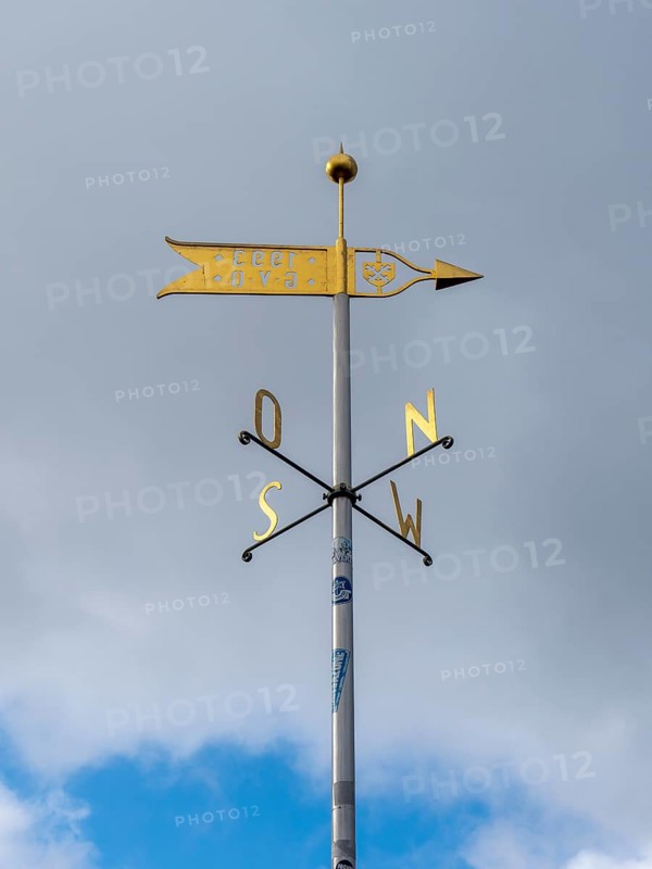 Metal wind arrow and wind chime for indicating cardinal points, north, south, east, west, Germany, Europe